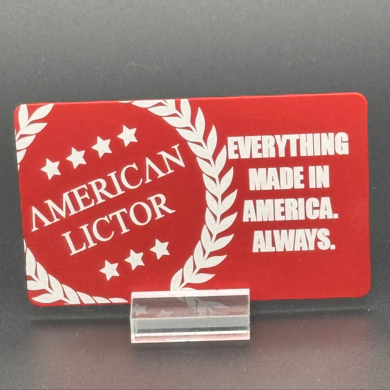 A red metal giftcard with the American Lictor Logo and Slogan