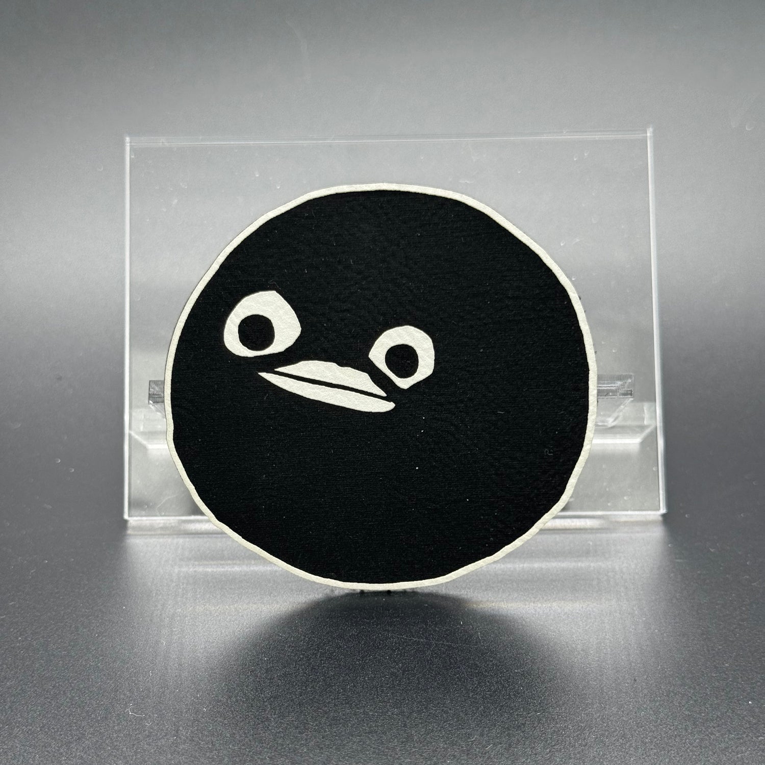 A leatherette patch of goofy cartoon character head wearing a ski mask