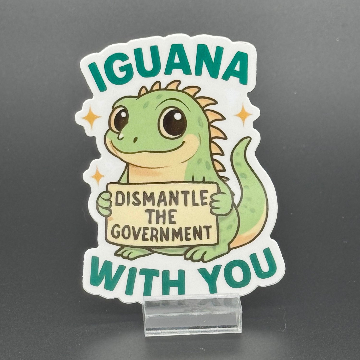 Sticker of a Green Cartoon Iguana holding a sign saying