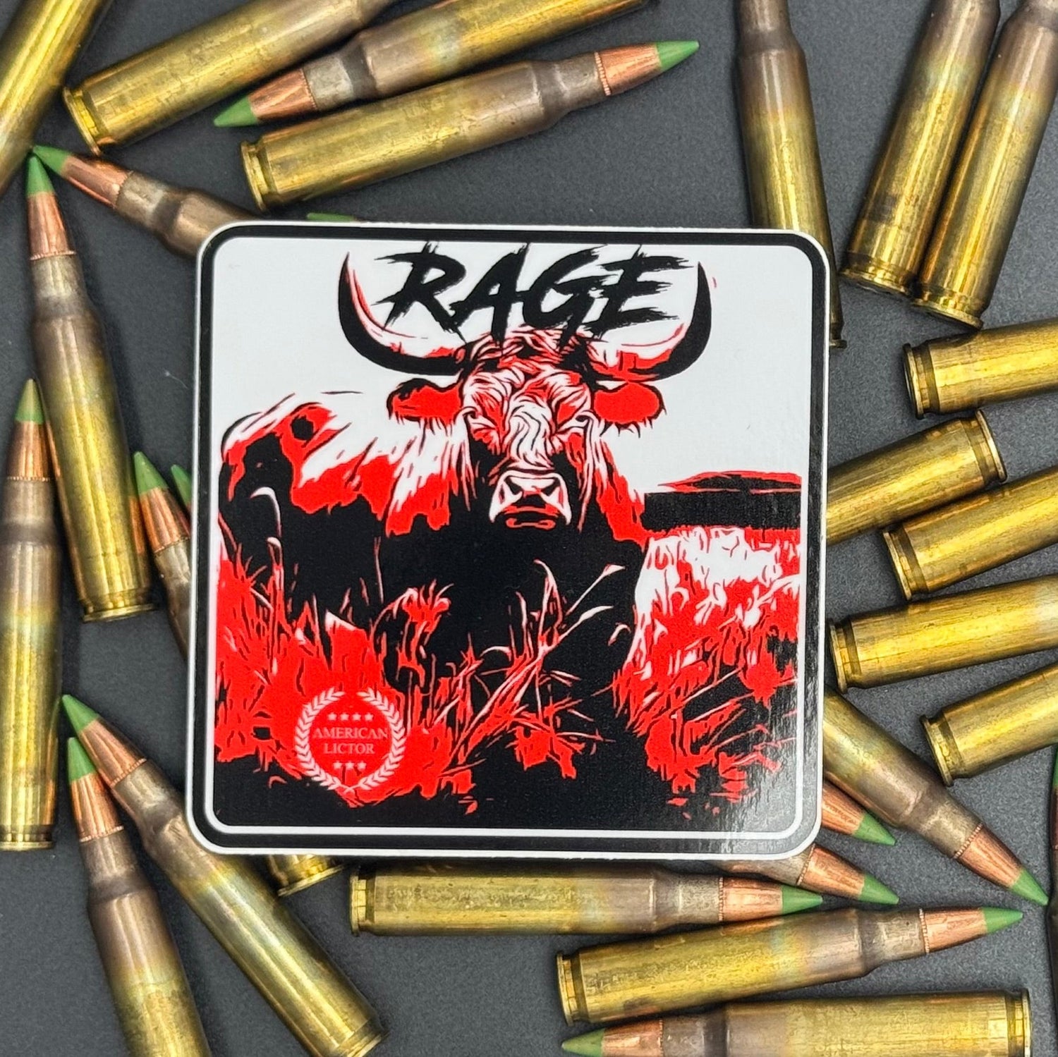 Black, red and white sticker of a bull with the text 'Rage' on a bed of ammo