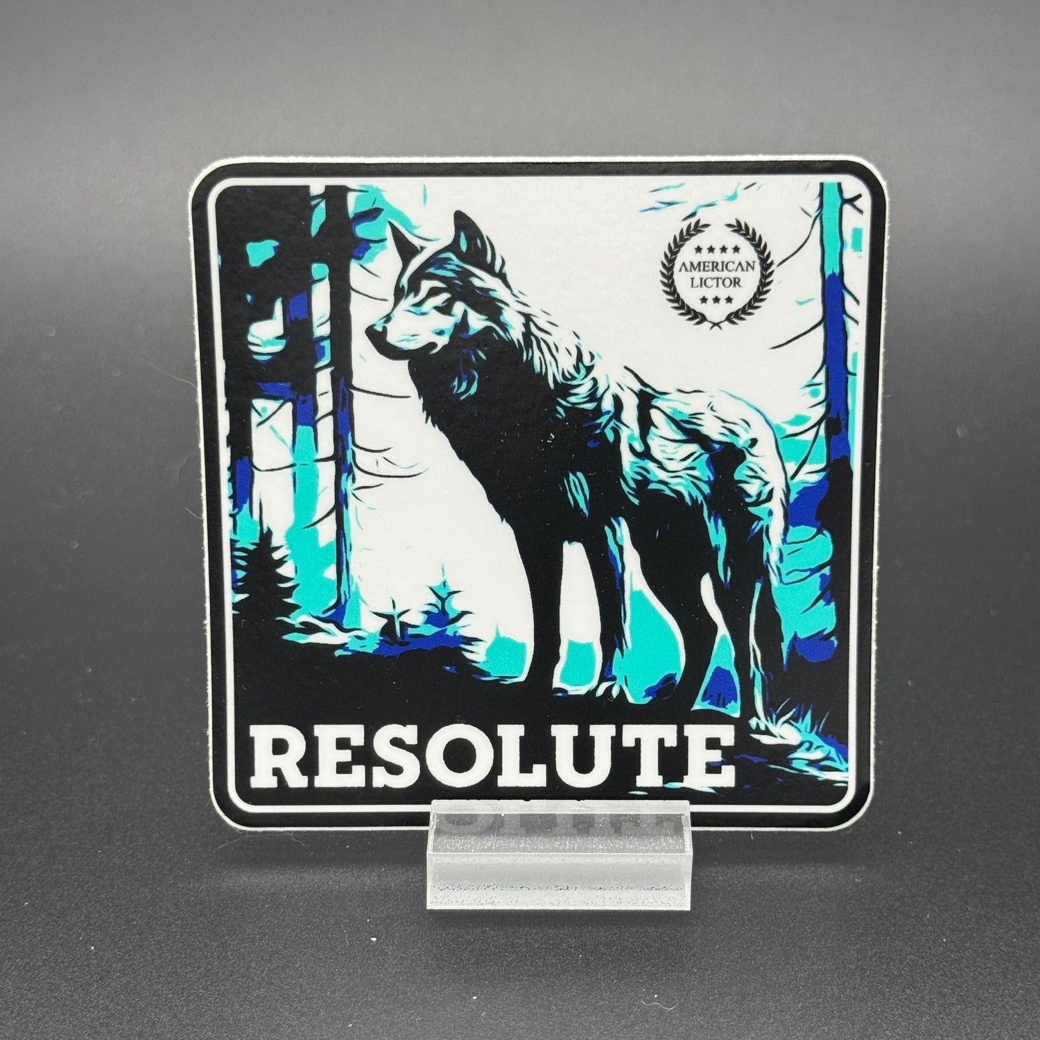 Black, blue and white Sticker of a wolf with the text ''Resolute