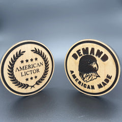 Two circular wooden coasters with the American Lictor Laurel Logo and 'Demand American Made' Designs