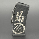 A black keychain shaped like an AR15 mag with the American Lictor logo and slogan Demand American Made'