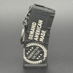 A black keychain shaped like an AR15 mag with the American Lictor logo and slogan Demand American Made'