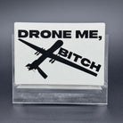 A white leatherette patch of a reaper drone and the text 'Drone Me, Bitch'