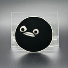 A leatherette patch of goofy cartoon character head wearing a ski mask