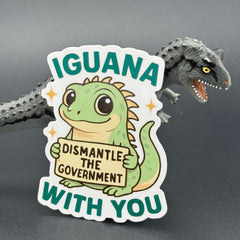 Sticker of a Green Cartoon Iguana holding a sign saying "Iguana dismantle the government with you" posing with a dinosaur