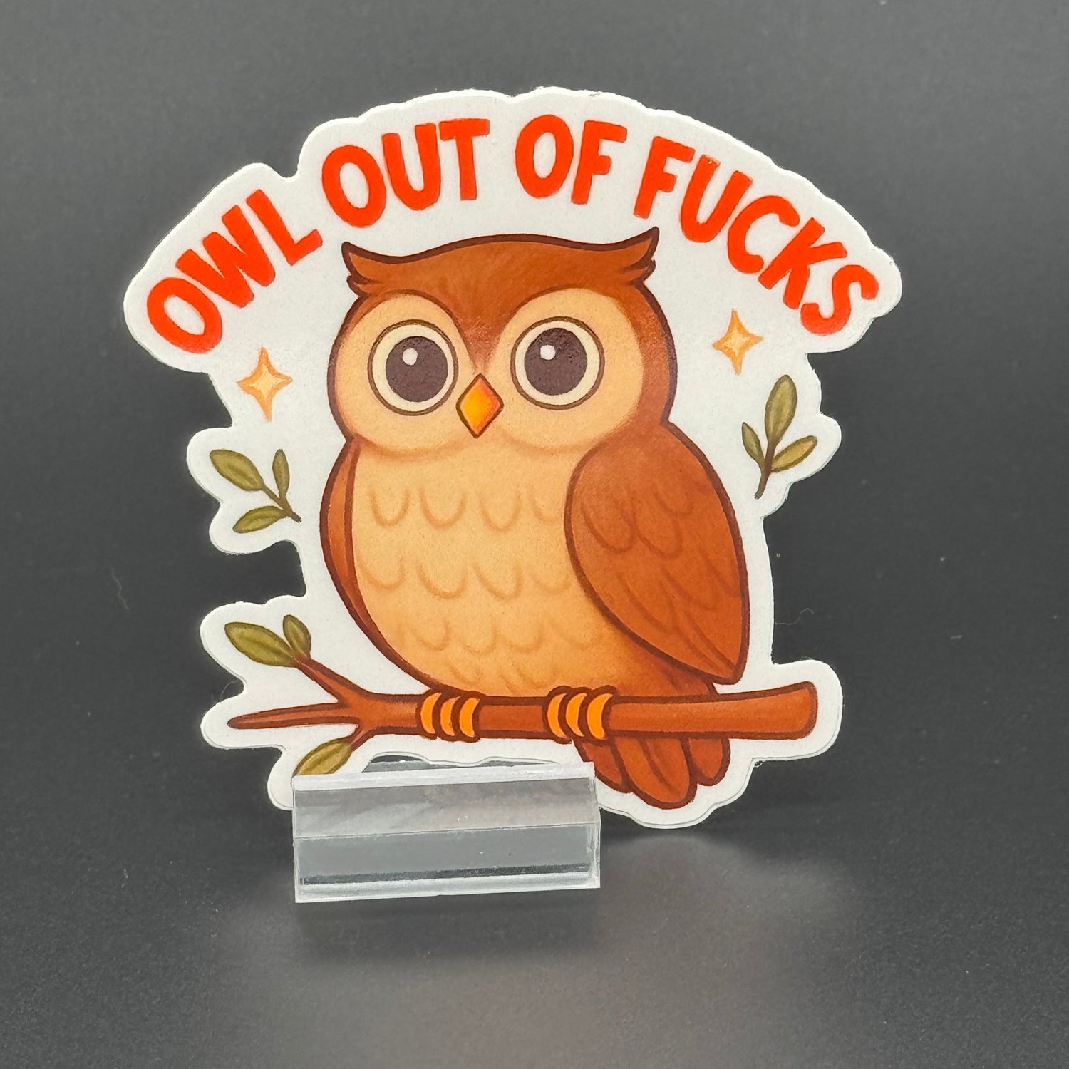 Sticker of a cute owl on a branch saying 