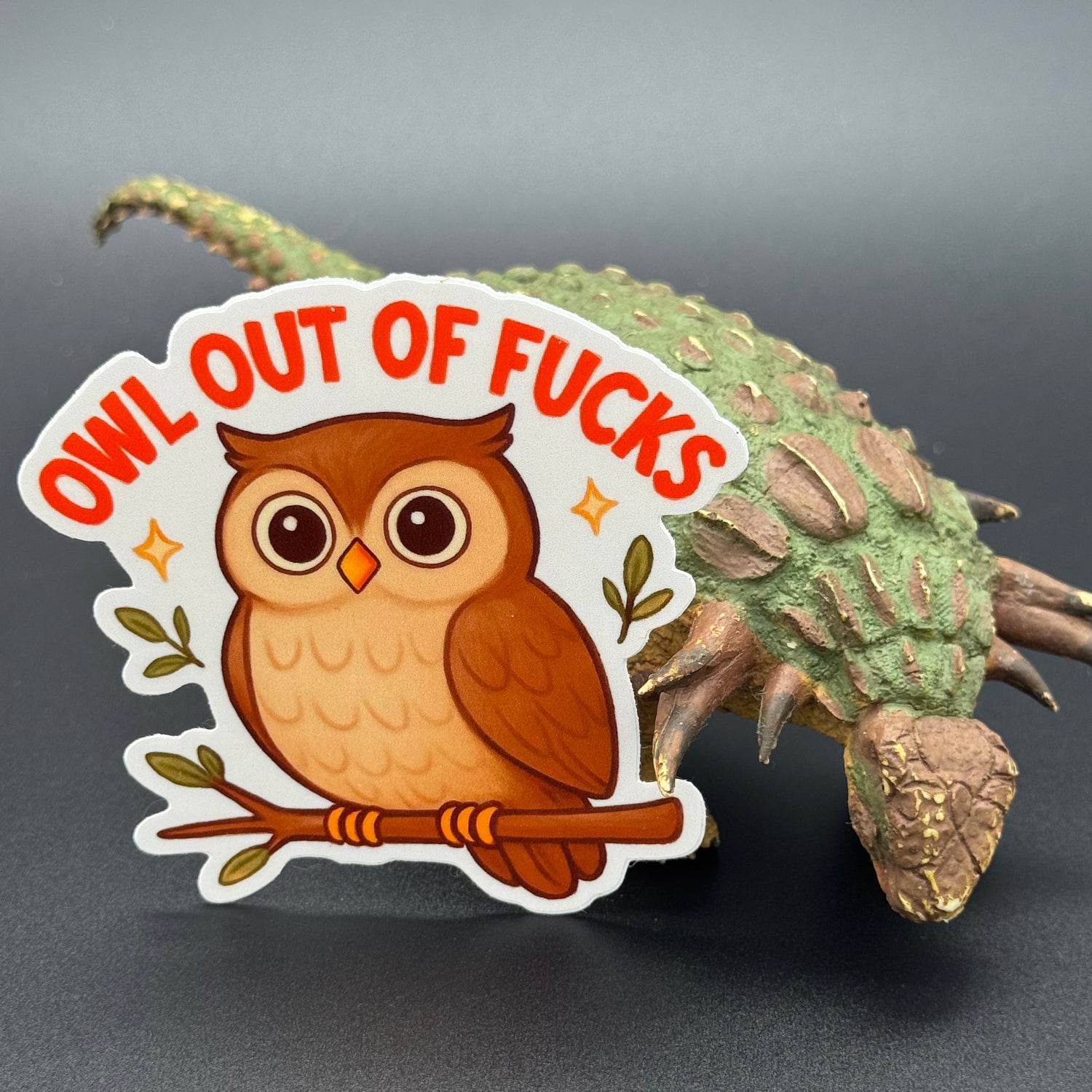 Sticker of a cute owl on a branch saying 