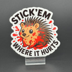Sticker of a cute porcupine covered in blood saying "Stick 'em where it hurts"