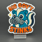Sticker of a cute skunk in a gas mask saying "Big government stinks"