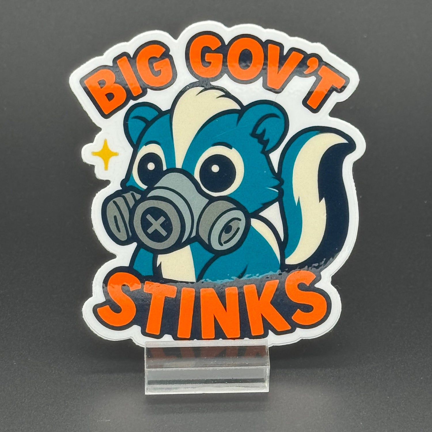 Sticker of a cute skunk in a gas mask saying 
