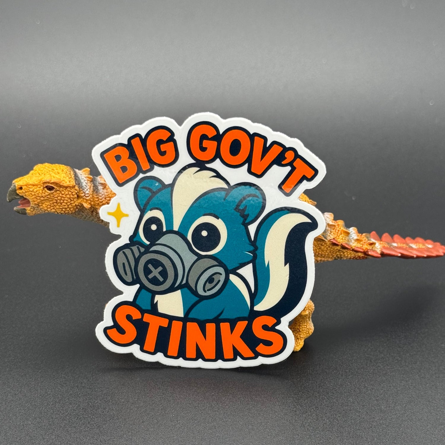 Sticker of a cute skunk in a gas mask saying 