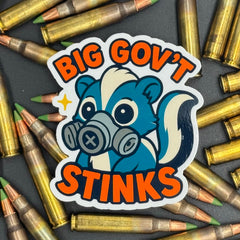 Sticker of a cute skunk in a gas mask saying "Big government stinks" on a bed of ammo