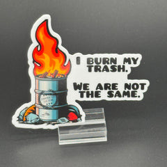 Sticker of an oil drum fire with the American Lictor Logo and the text "I burn my trash we are not the same"