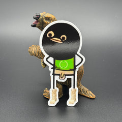 Sticker of a cartoon character wearing a ski mask with no pants on posing with a prehistoric mammal