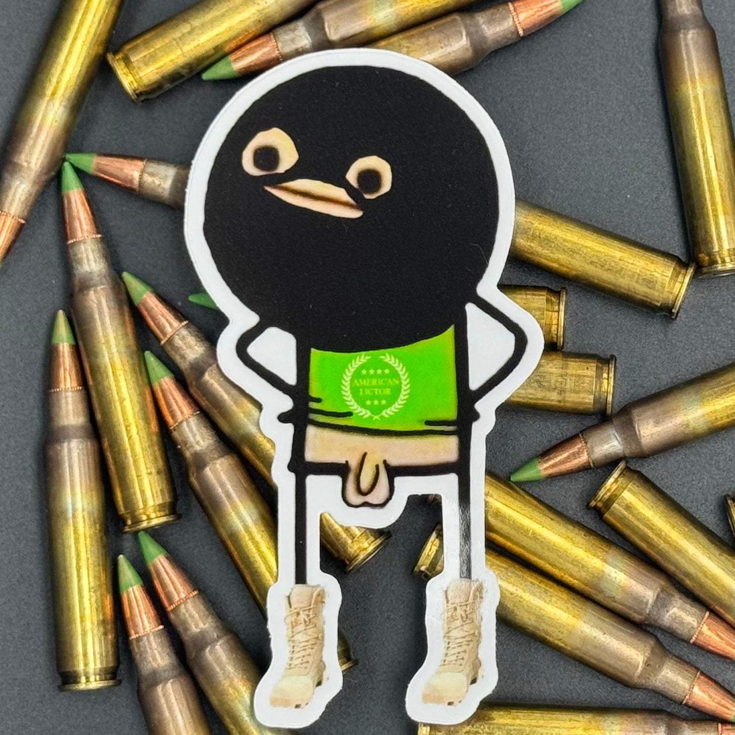 Sticker of a cartoon character wearing a ski mask with no pants on on a bed of ammo