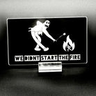 Sticker of a cartoon character in a ghost suit roasting a marshmallow over a fire