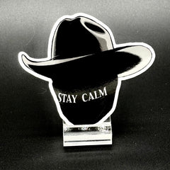 Sticker of a masked man with a black cowboy hat and the text 'Stay Calm'