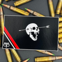 Sticker of a modern pirate flag with a skull with open mouth and arrow through the head and an upside down crown on a bed of ammo