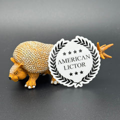 Sticker of the American Lictor Logo in white posing with a prehistoric mammal