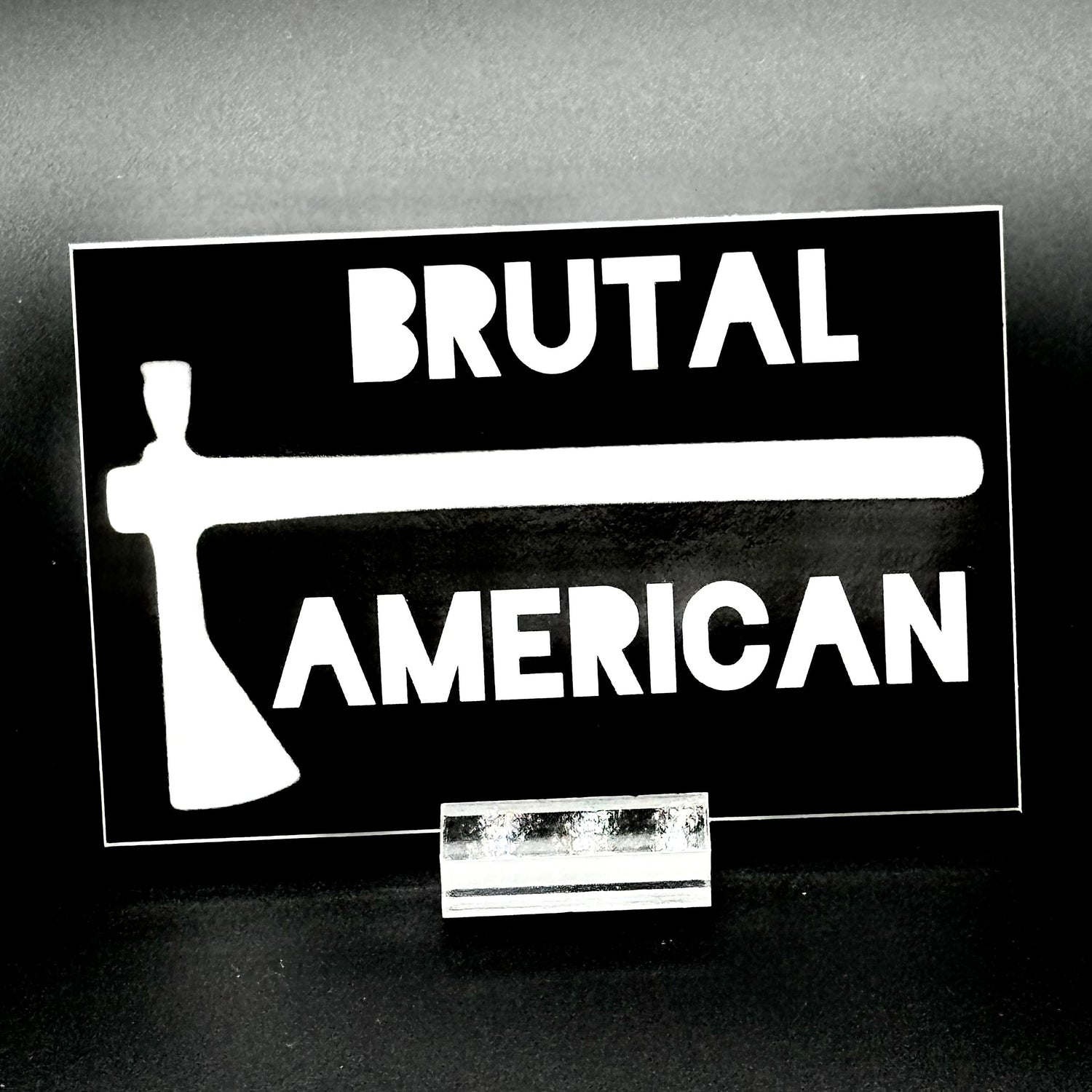 Black sticker with a tomahawk and the text 'Brutal American'