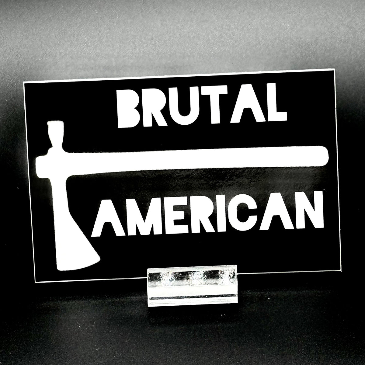 Black sticker with a tomahawk and the text 'Brutal American'