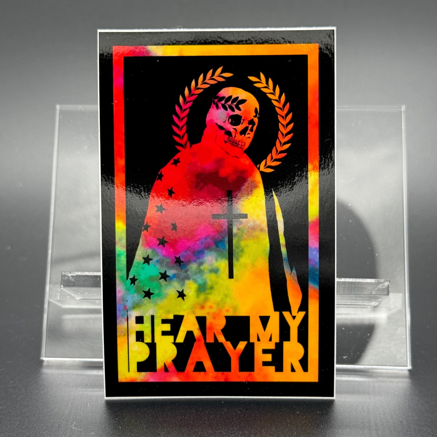 Chromatic sticker of a man draped in the American Flag with the text 'Hear my Prayer'