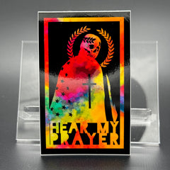 Chromatic sticker of a man draped in the American Flag with the text 'Hear my Prayer'