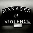 Black sticker with the text 'Manager of Violence'