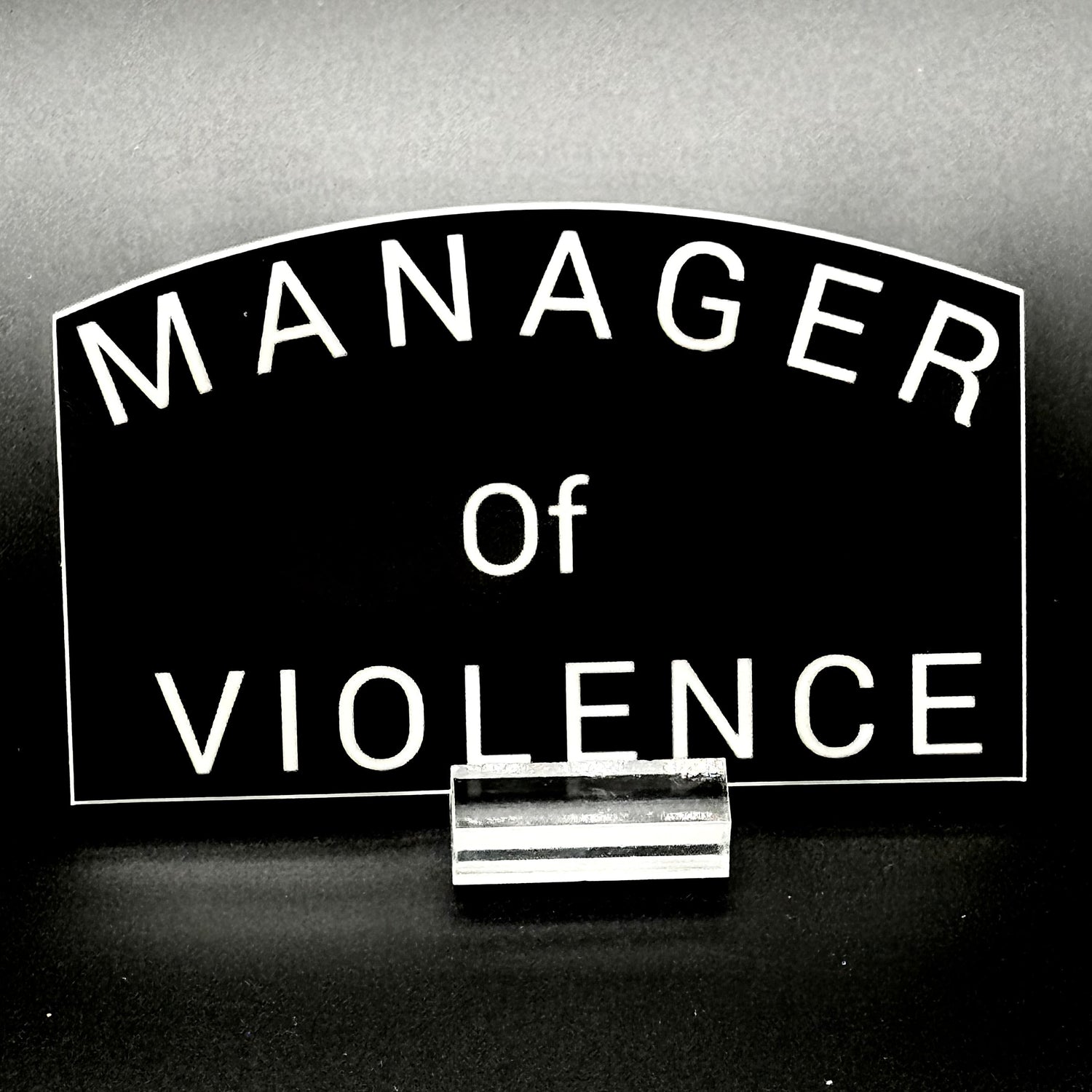Black sticker with the text 'Manager of Violence'