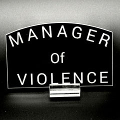 Black sticker with the text 'Manager of Violence'