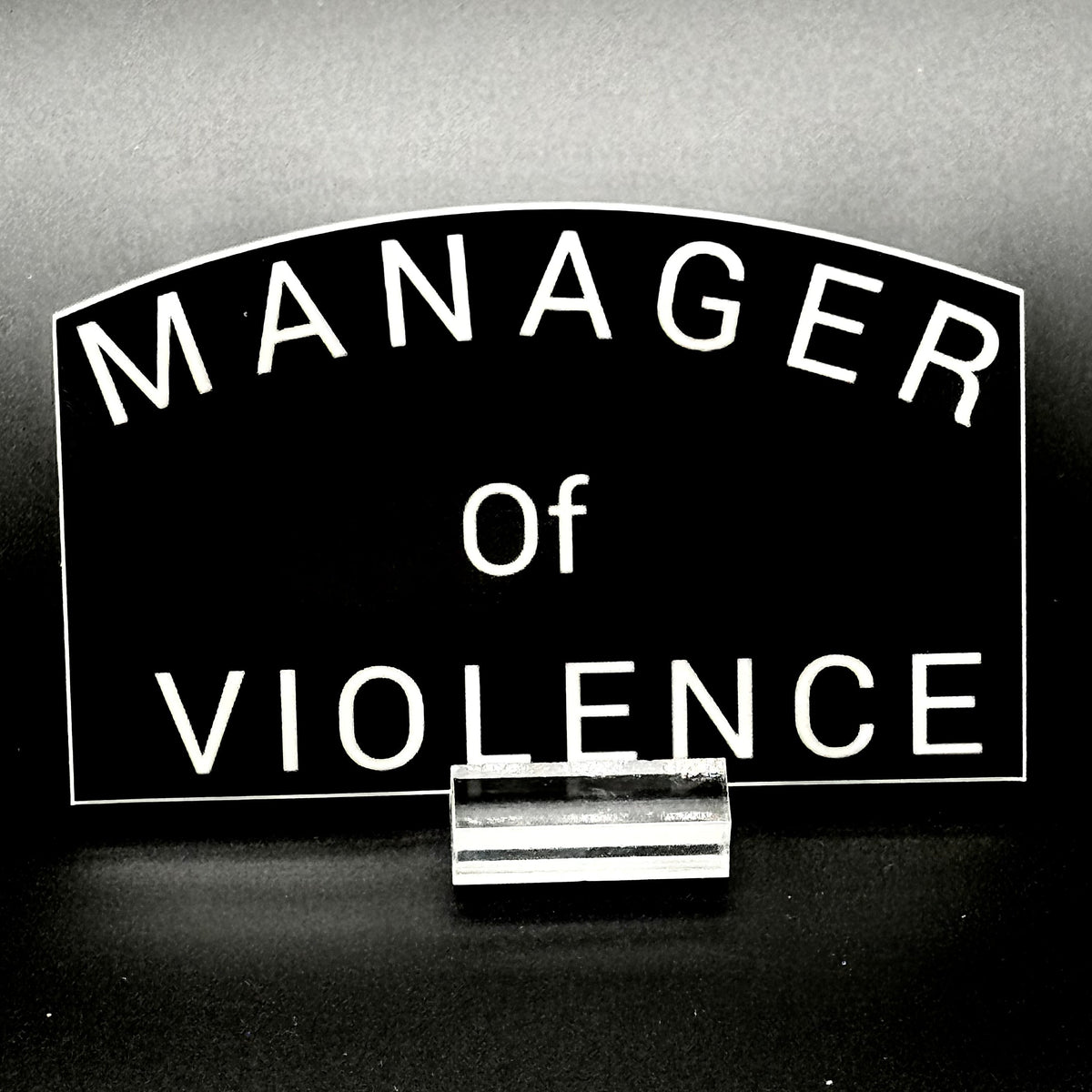Black sticker with the text 'Manager of Violence'