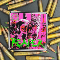 Black, green and pink sticker of a bobcat with the text 'Reaper' on a bed of ammo