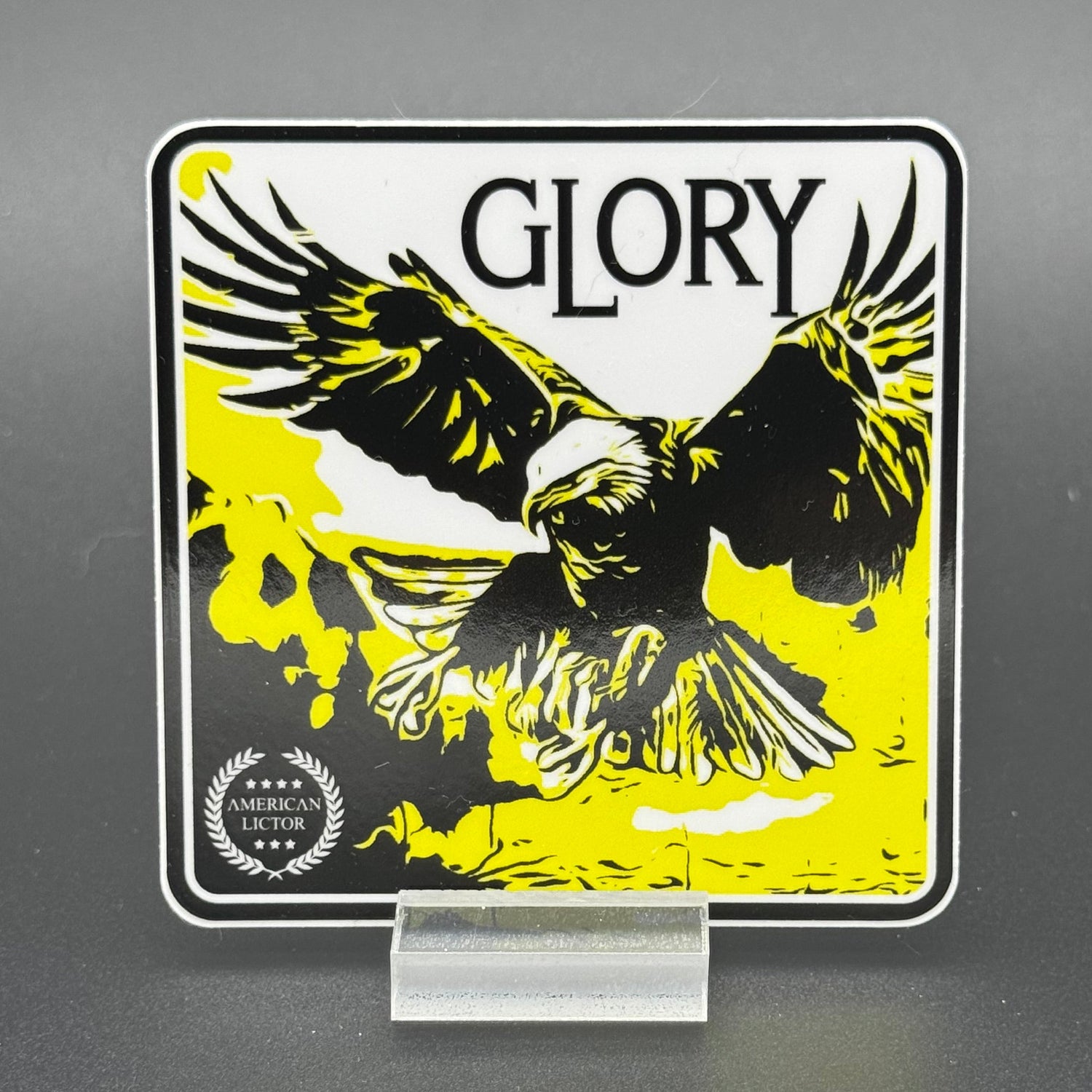 Black, yellow and white sticker of an eagle with the text 'Glory'
