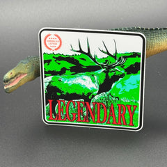 Green, red an White sticker of an elk with the text 'Legendary' posed with a dinosaur