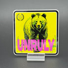 Yellow and pink Sticker of a grizzly bear with the text 'Unruly'