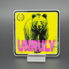 Yellow and pink Sticker of a grizzly bear with the text 'Unruly'