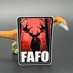 Black, red Sand white sticker of a Moose with the text 'FAFO' posed with a dinosaur