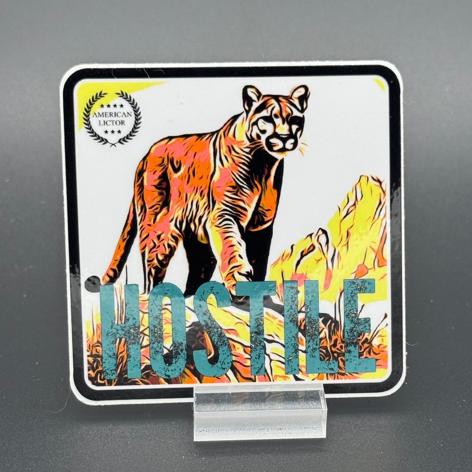 Multicolor sticker of a mountain lion with the text 'Hostile'