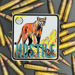 Multicolor sticker of a mountain lion with the text 'Hostile' on a bed of ammo