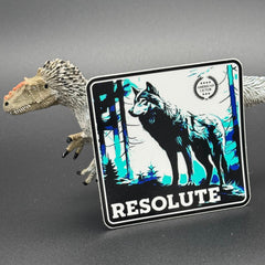Black, blue and white Sticker of a wolf with the text ''Resolute' posed with a dinosaur